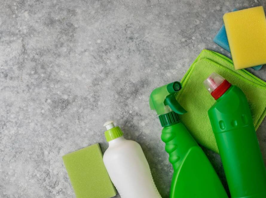 Green-cleaning supplies with reusable plastic detergent bottles and sustainable tools