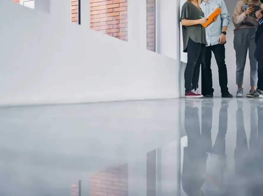 Students stand in a hallway with a freshly refinished floor.