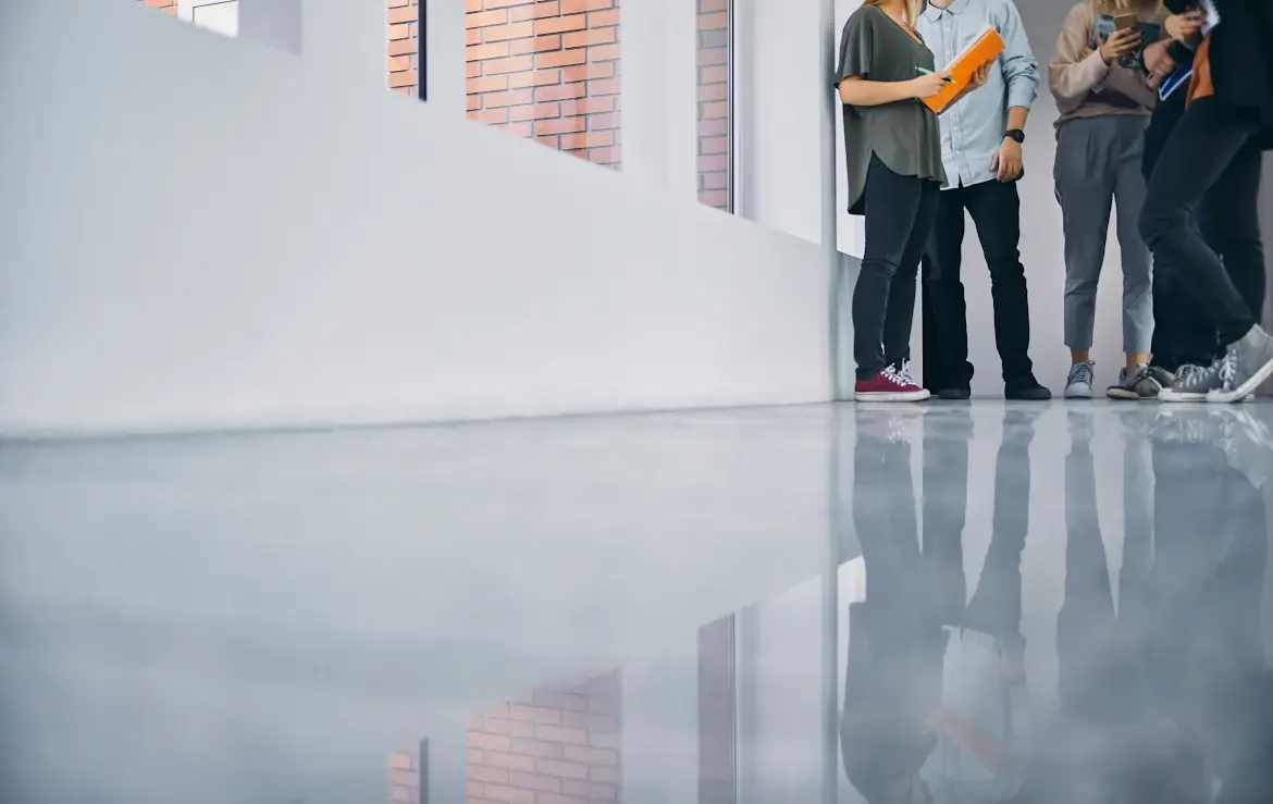 Students stand in a hallway with a freshly refinished floor.
