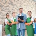 Cleaning staff in uniform posing with a supervisor during a commercial facility walkthrough