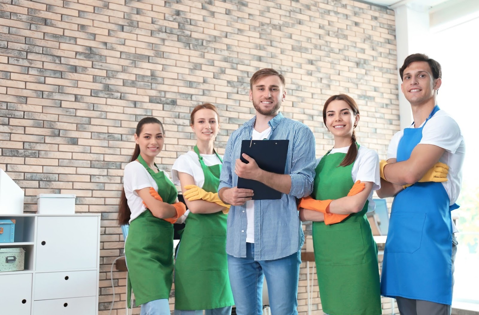 Cleaning staff in uniform posing with a supervisor during a commercial facility walkthrough - Paragon Peak Building Maintenance Cleaning staff in uniform posing with a supervisor during a commercial facility walkthrough