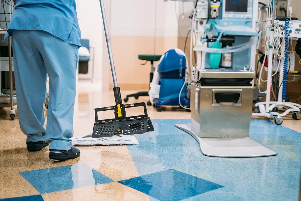 Professional janitor cleaning a medical facility. - Paragon Peak Building Maintenance Professional janitor cleaning a medical facility.