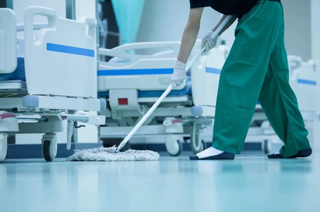 Professional janitor cleaning a medical facility. - Paragon Peak Building Maintenance Professional janitor cleaning a medical facility.